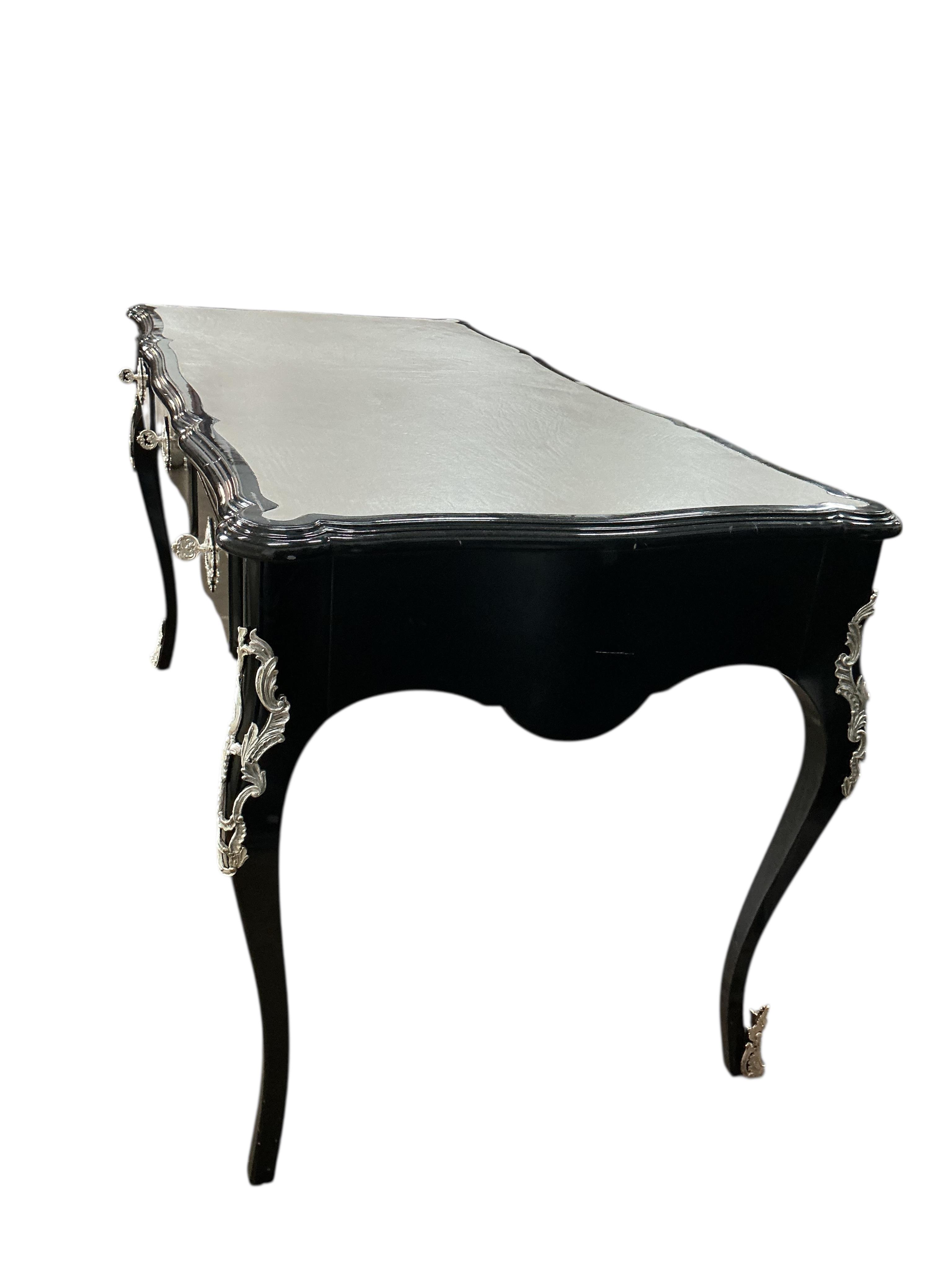 A Contemporary Louis XVI style ebonised bureau plat, width 146cm, depth 71cm, height 79cm